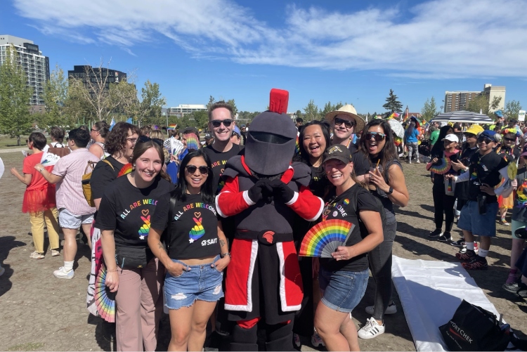 SAIT Pride banner, photo of students smiling