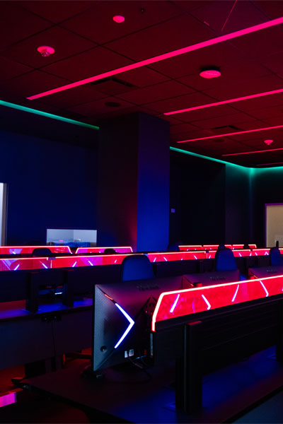 Insight the SAIT Downtown cyber range, featuring illuminated desks with vibrant red and blue LED lights.
