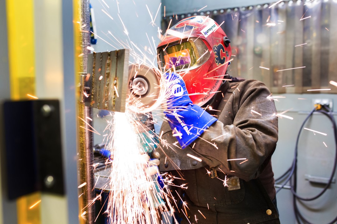 Person welding with safety helmet