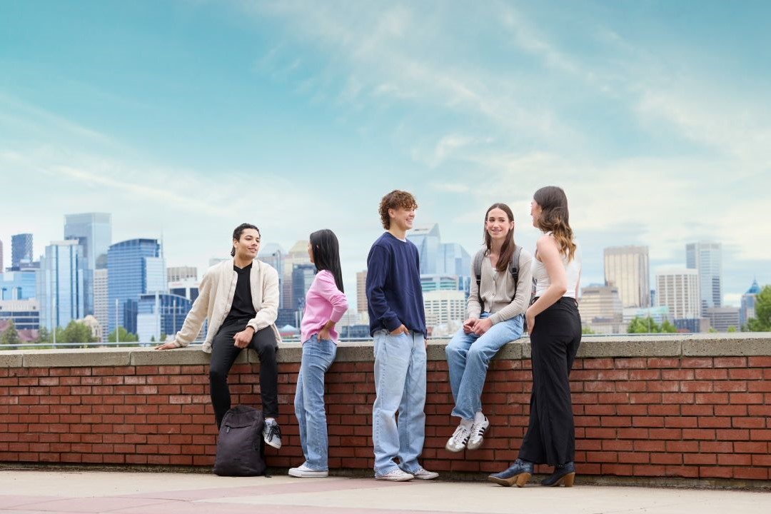 Group of students sitting on a wall