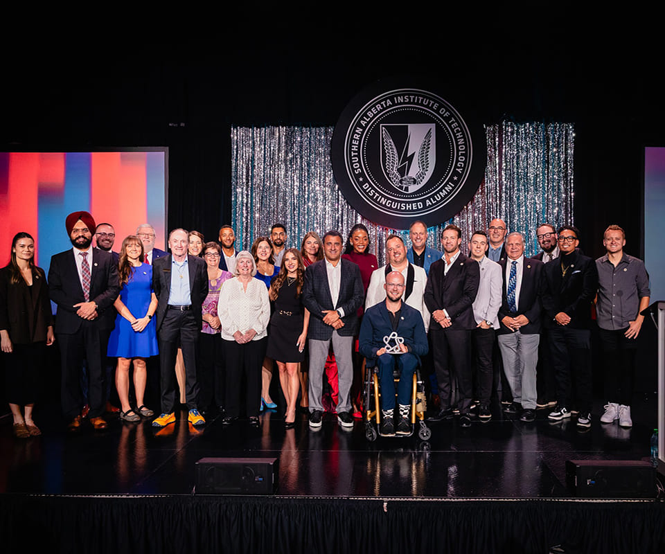 Group photo of the distinguished alumni from the Alberta Institute of Technology showcasing a diverse gathering of individuals celebrating their achievements.