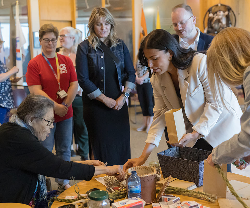 A diverse group of people participating in a hands-on workshop, focusing on traditional crafts and community engagement.