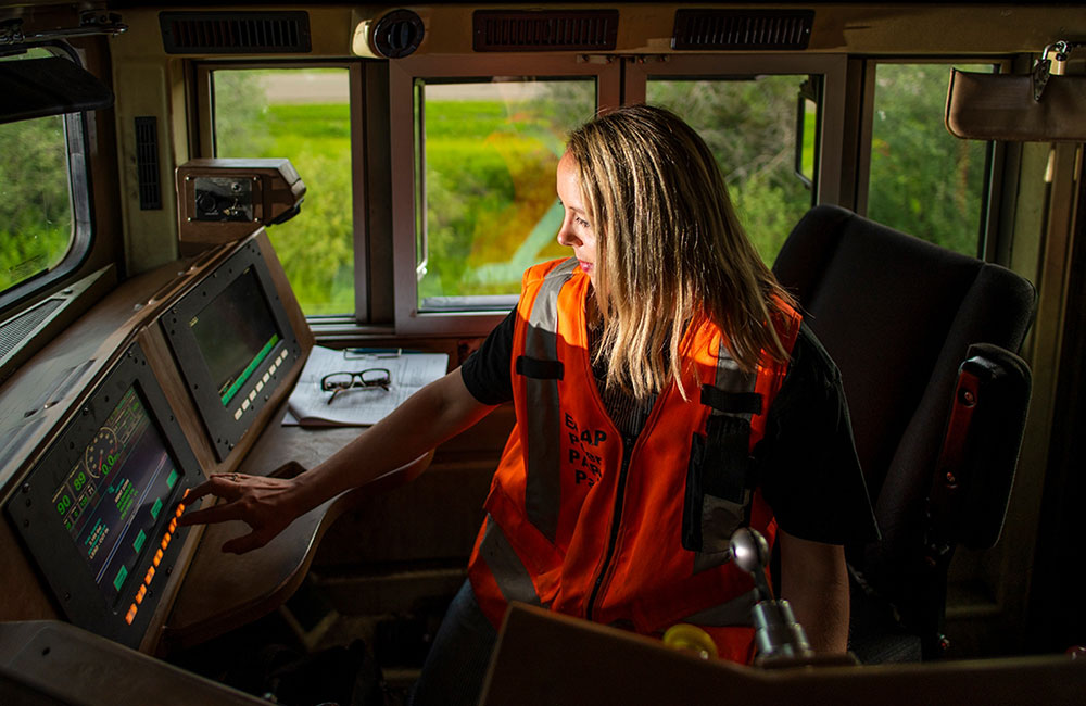 Leslie Lukan inside the train engine working on dashboard