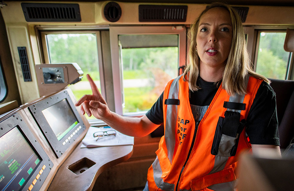 Leslie Lukan  wearing high-vis vest, long blonde hair