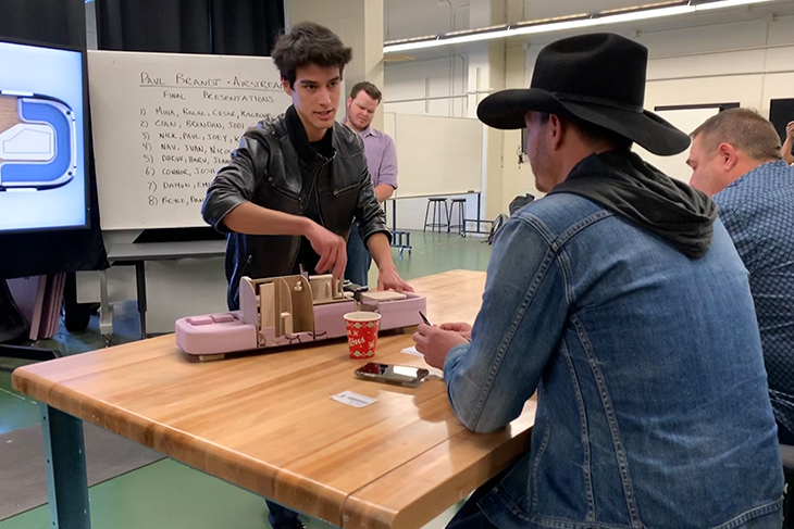Paul Brandt and the instructor getting the details of the group's presentation.