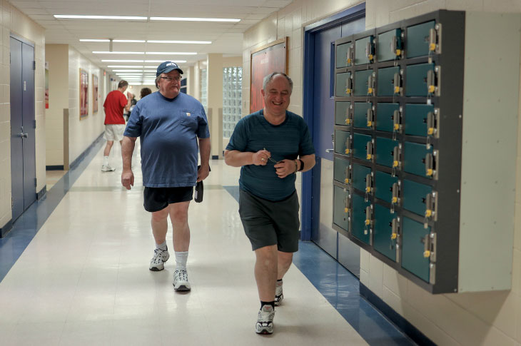 Two Youquest members walk the hallways in SAIT's Campus Centre.