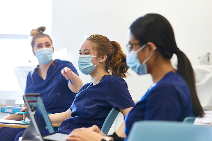 Optician students with masks on in classroom