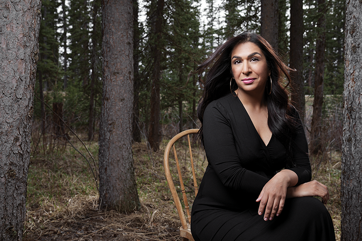 Shazhia Noorally sitting on chair outside