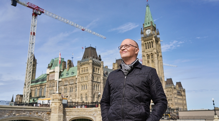 Tim Lazaruke in front of Centre Block building