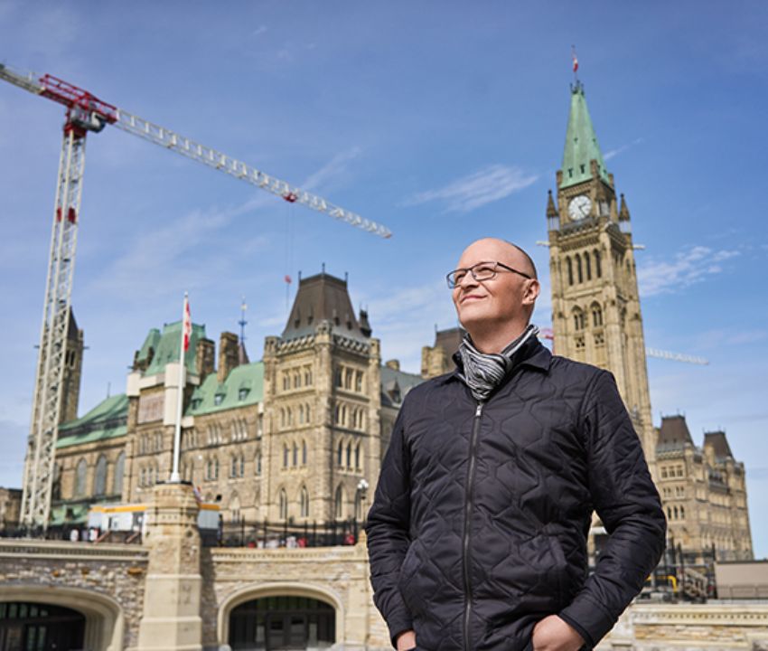 Tim Lazaruke in front of Centre Block building