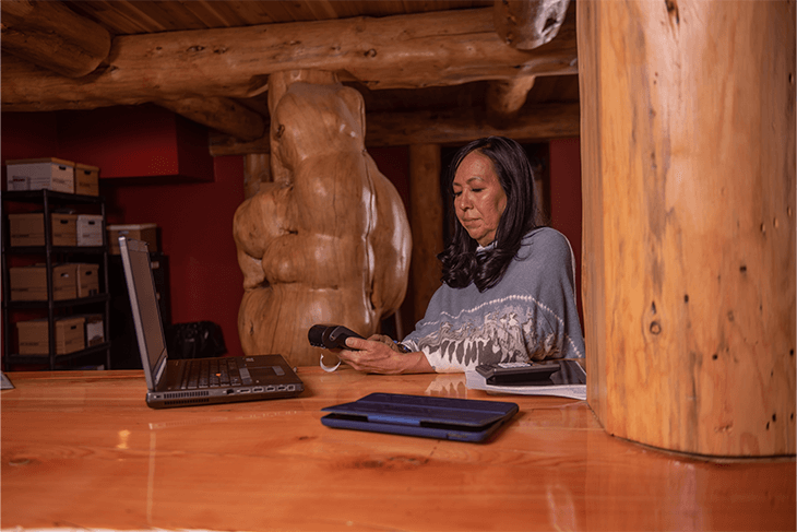 Marcella Brooks inside doing administrative work. She is looking at her computer