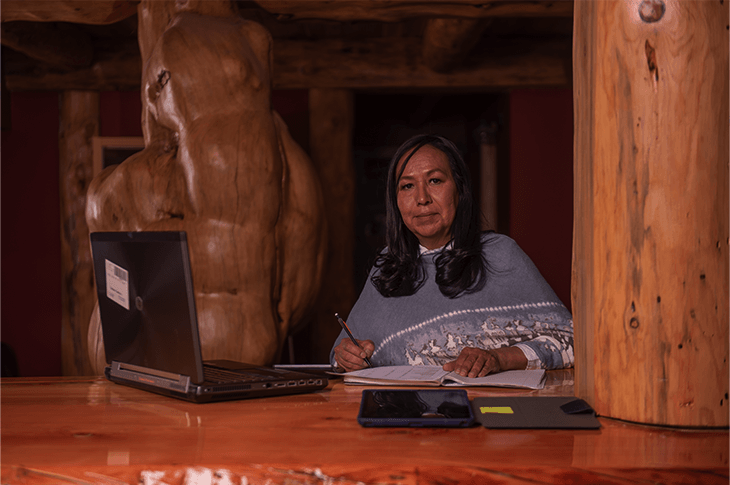 Marcella Brooks inside doing administrative work. She is looking at the camera