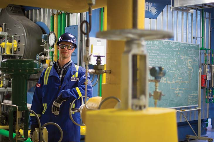 trades student posing in safety gear in classroom at SAIT