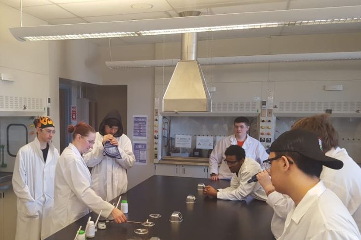 students gather in science lab