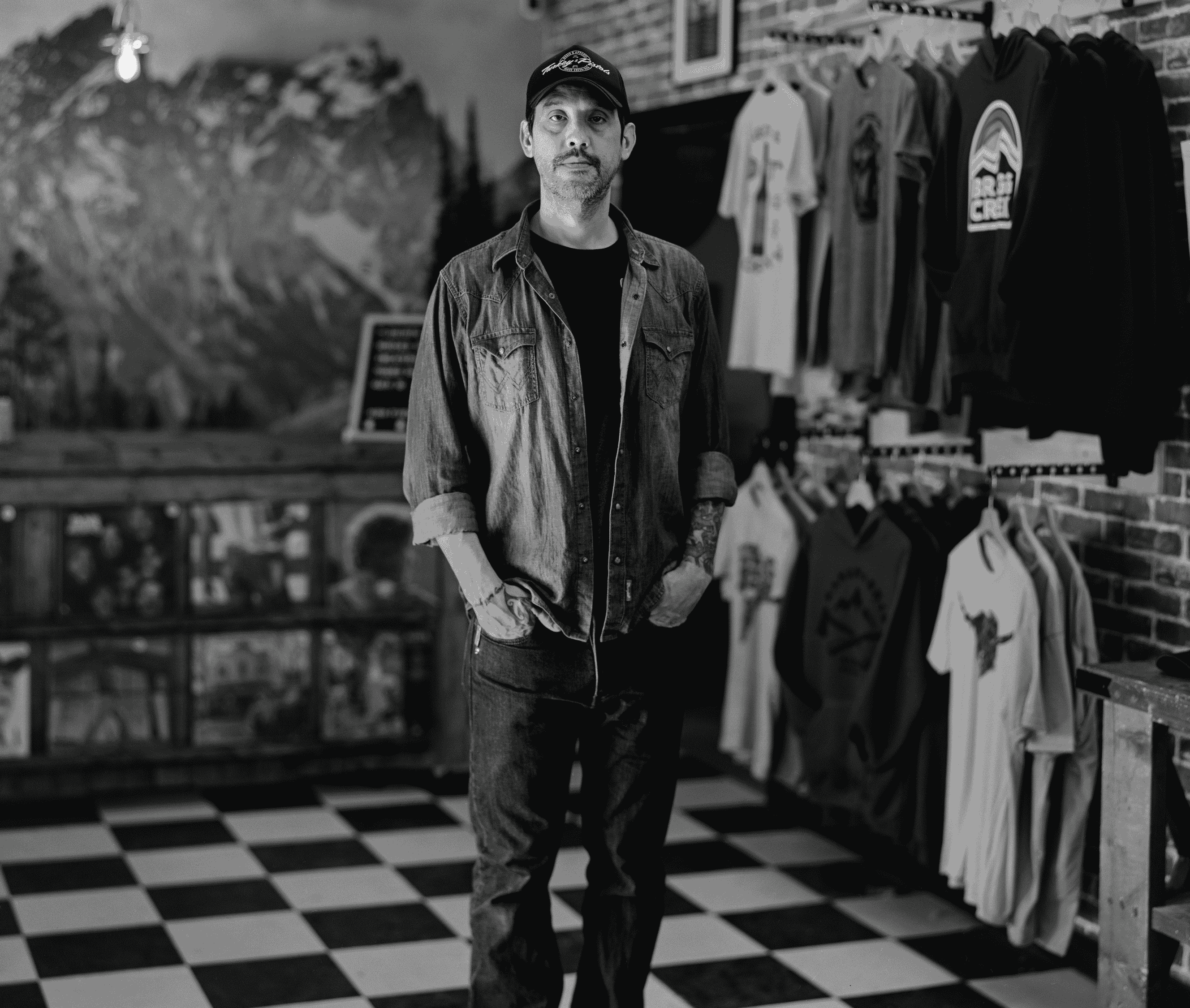 Black and white photo of man standing in store