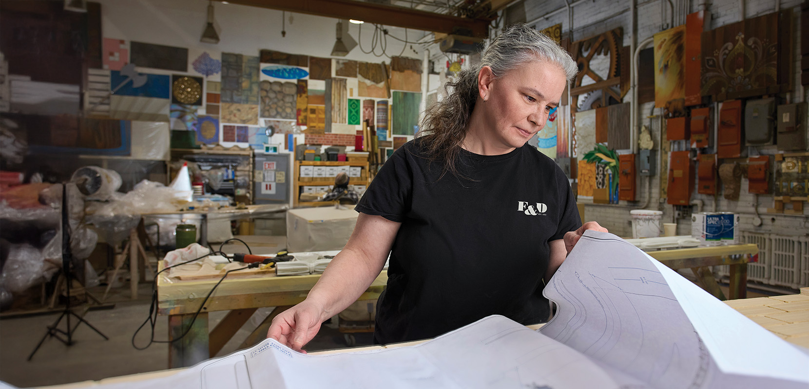 Shannon Fraser reviews a document in the workshop.