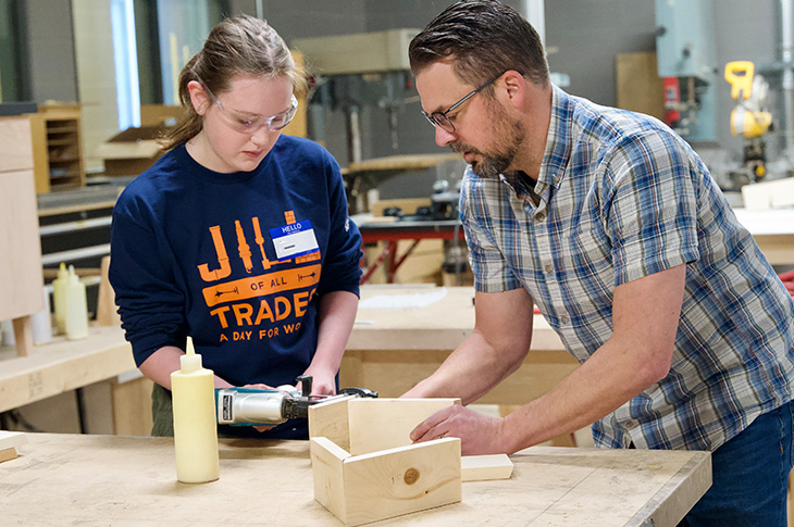 young girl and man doing some carpentry