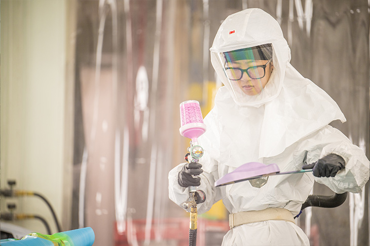 Young student using a spray gun