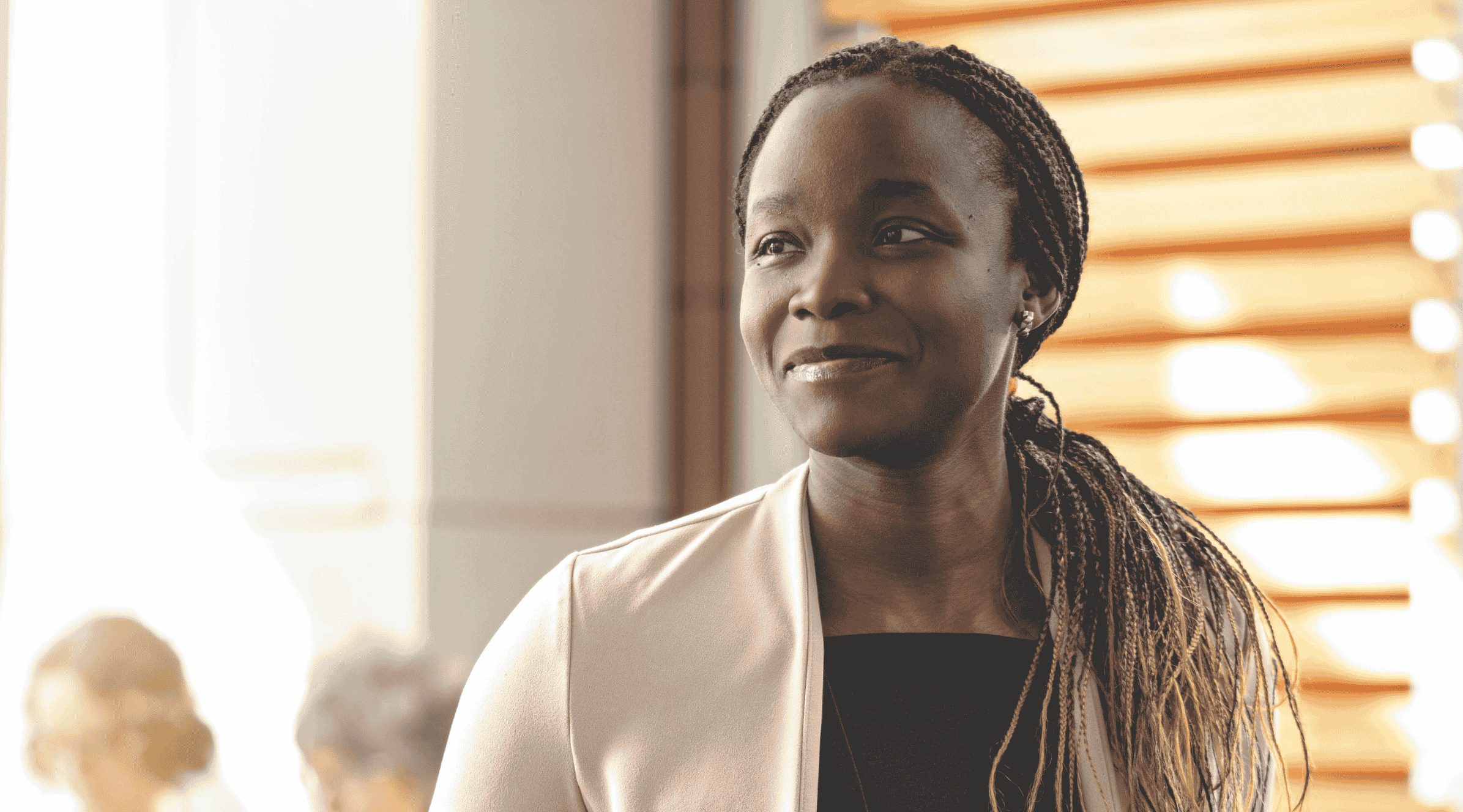 A woman in business casual clothing smiling