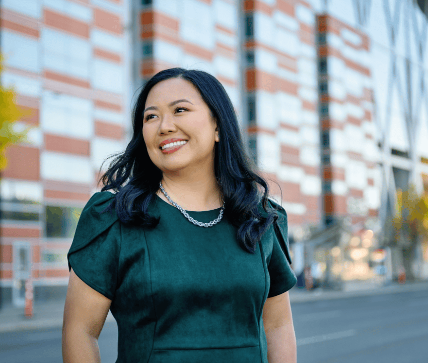 young female wearing green dress looking off camera