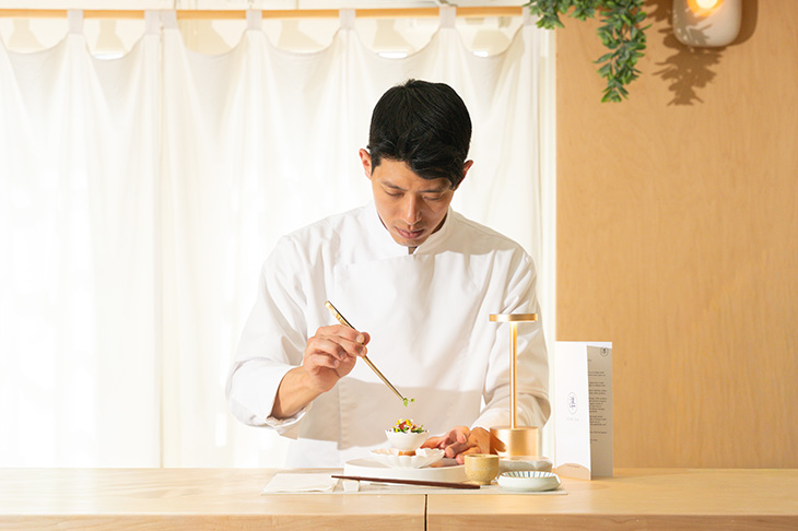 Chef Jun Young Park carefully prepares a dish in his restaurant, Ryuko.