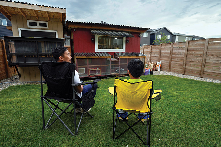 father and son holding pigeons