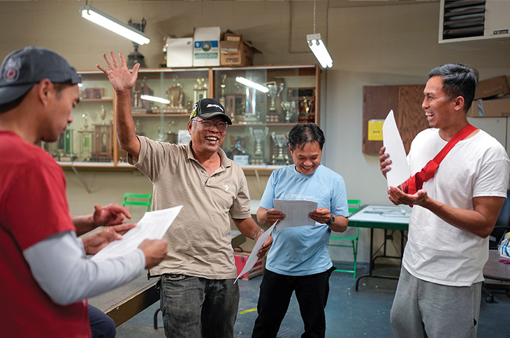 four males standing together celebrating