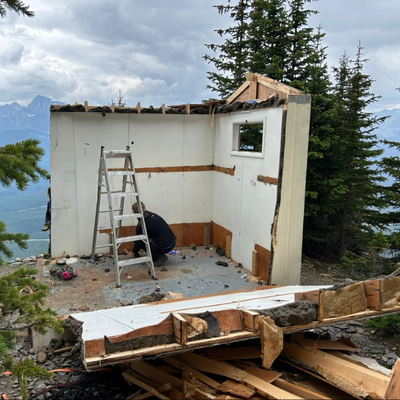 Partially torn-down cabin.