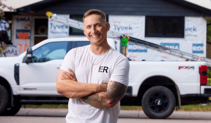 Caucasian man in white shirt standing in front of worksite
