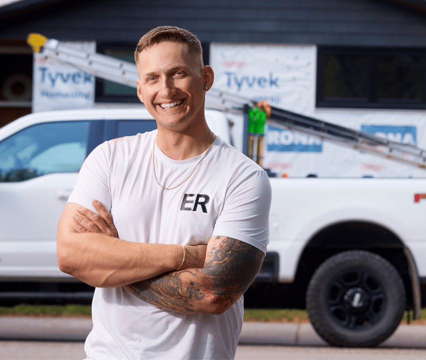 Caucasian man in white shirt standing in front of worksite