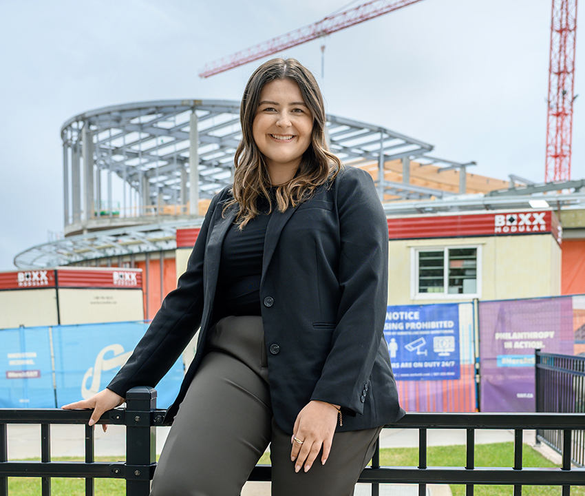 Sophie stands in front of a construction site