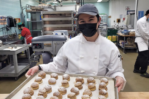 Hospitality student showing off her baked goods