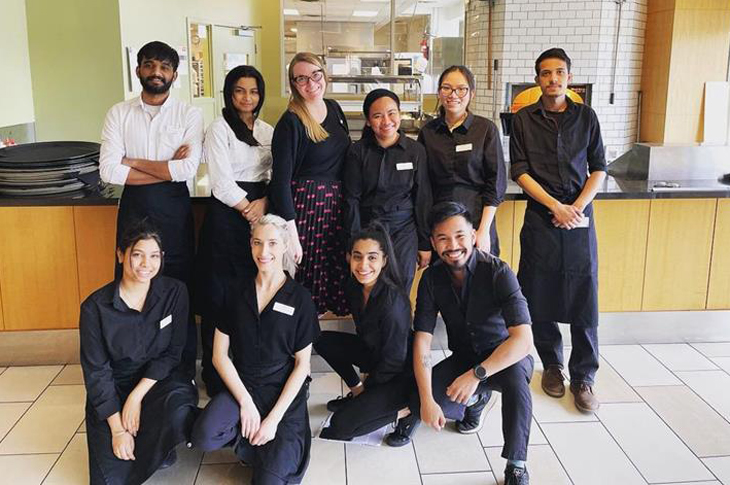 SAIT hospitality and tourism students smiling with instructor