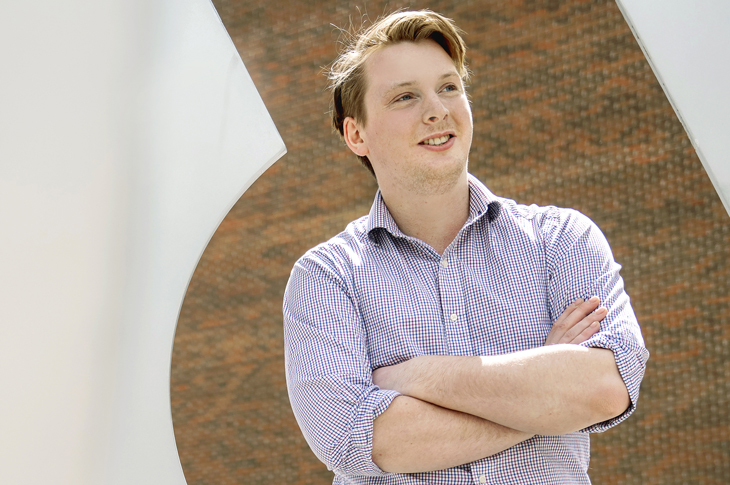 Liam Hunter standing cross-armed in front of SAIT Catalyst