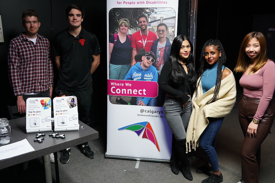 A group of students smile towards a the camera