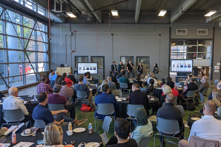 People sitting at tables in the AECOO Connector space