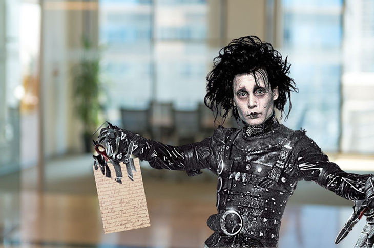 Edward Scissorhands holding a piece of paper