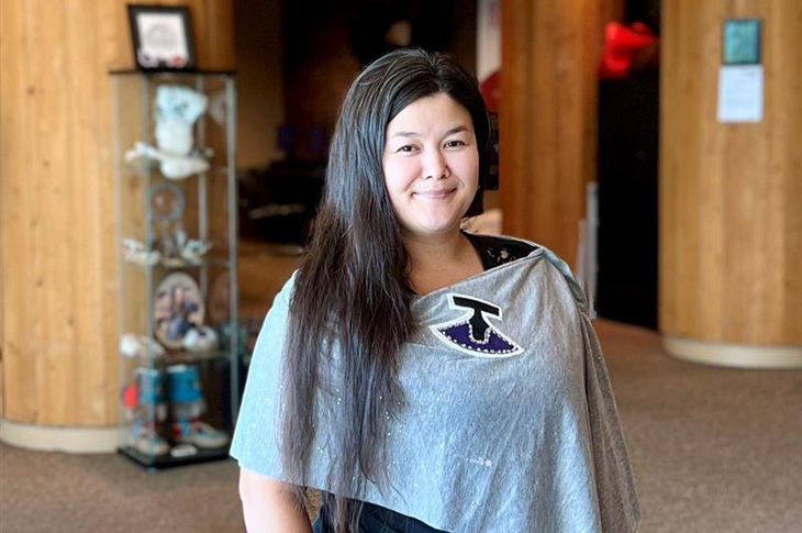 Tapaarjuk Moore smiling while standing in Chinook Lodge