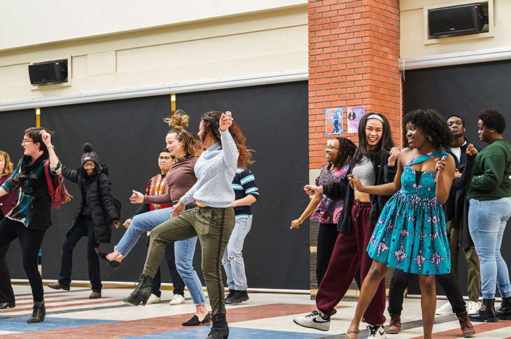 group of students dancing in the Irene Lewis Atrium