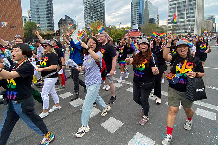 group of SAIT students and employees walking in the Calgary Pride Parade