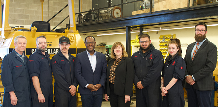 Heather Magotiaux, SAIT Vice President, External Relations, Kaycee Madu, Minister of Skilled Trades and Professions, Government of Alberta, Pat Robson, Instructor, School of Transportation, SAIT, and Mike Hughes, Interim Academic Chair, School of Transportation, SAIT pose with SAIT apprentices.