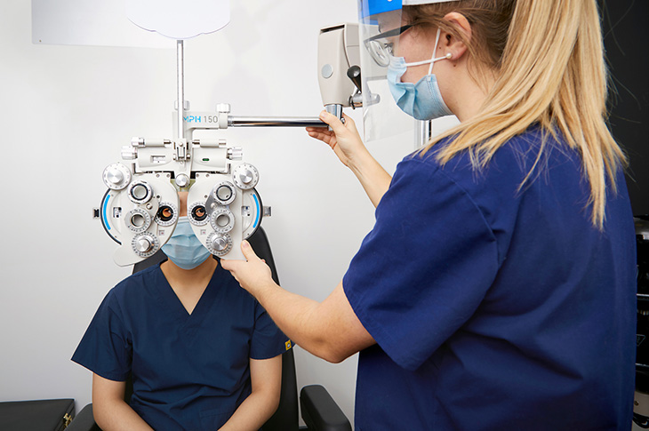 Vision care student performing eye exam