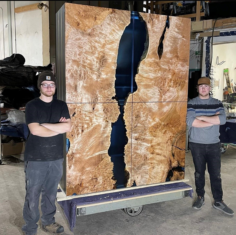 Jonathan Straub (on the right) with a finished cabinet ready to be delivered to a client. 
