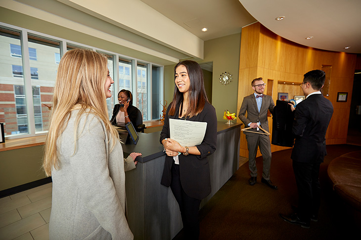 People stand an chat at the entrance of the Highwood restaurant on SAIT's main campus