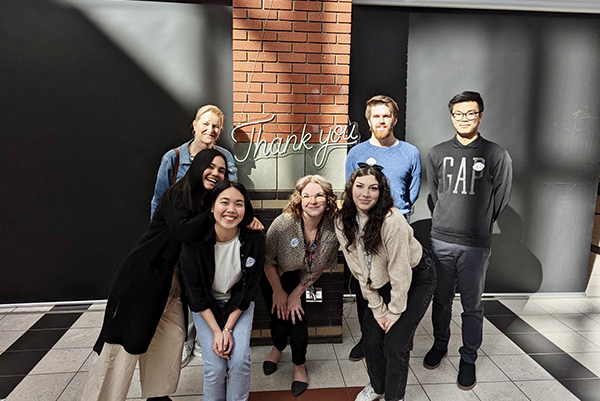 SAIT student Katleah poses for a photo with the marketing team