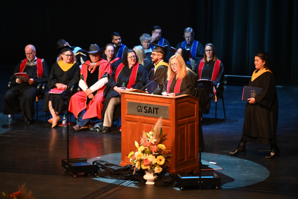 SAIT Journalism Instructor Vicki Hall announces graduates at SAIT’s 2023 Fall Convocation Ceremonies.
