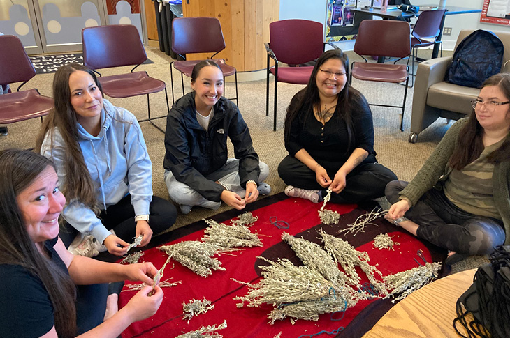 Indigenous students sorting sage at Natoysopoyiis