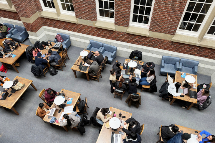 An overhead shot of students studying at tables inside of Stan Grad.