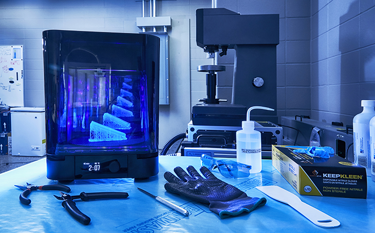 Tools and safety gear on a table in a 3D printing lab