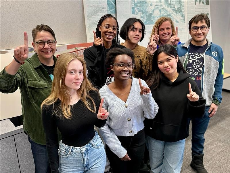 group of students holding up a number 1 finger